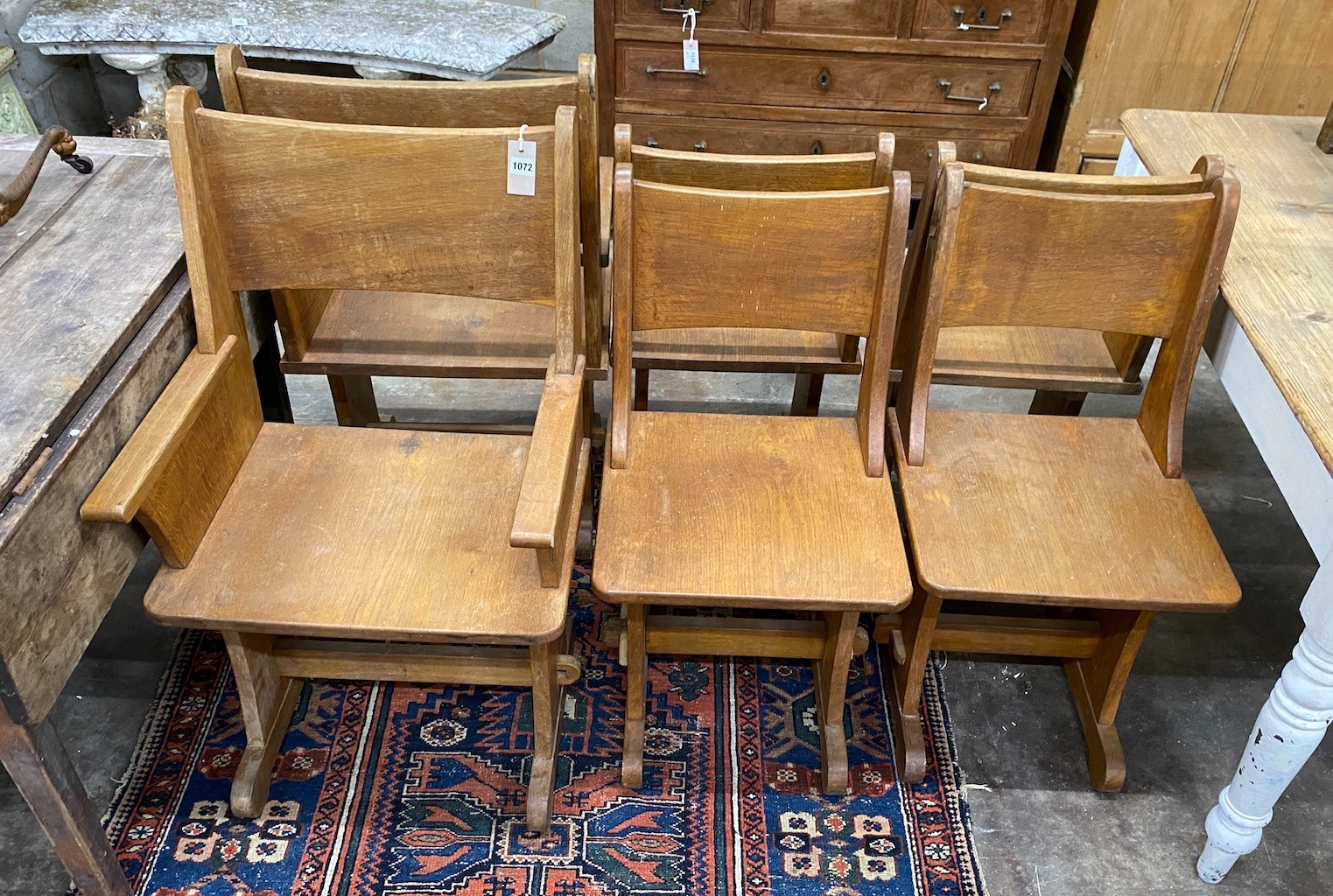 A set of six Gothic style oak dining chairs including a pair of carvers
